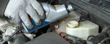 pouring brake fluid into car