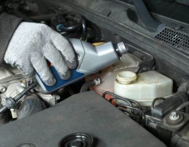 pouring brake fluid into car